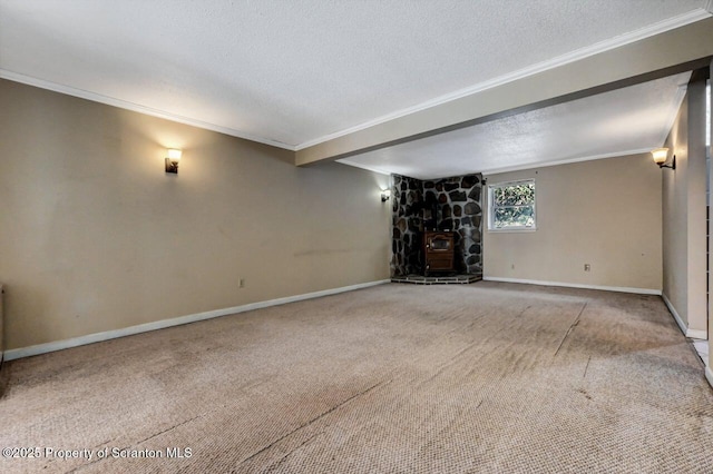 unfurnished living room featuring a textured ceiling, carpet floors, ornamental molding, and a wood stove