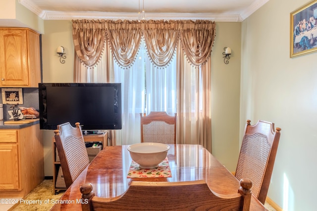 dining space with crown molding