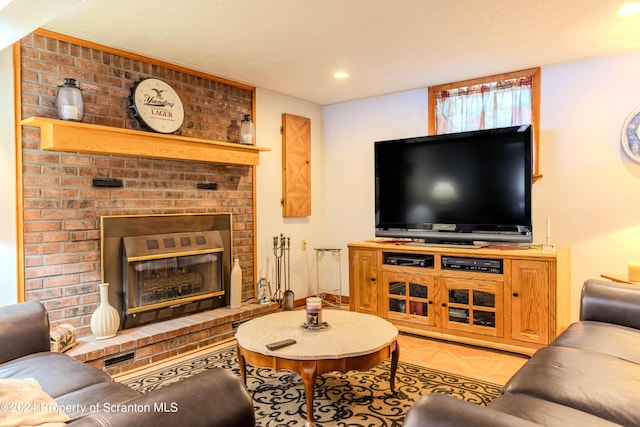 living room featuring a brick fireplace