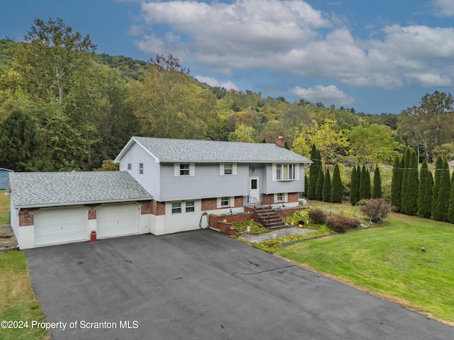 view of front of home with a front yard and a garage