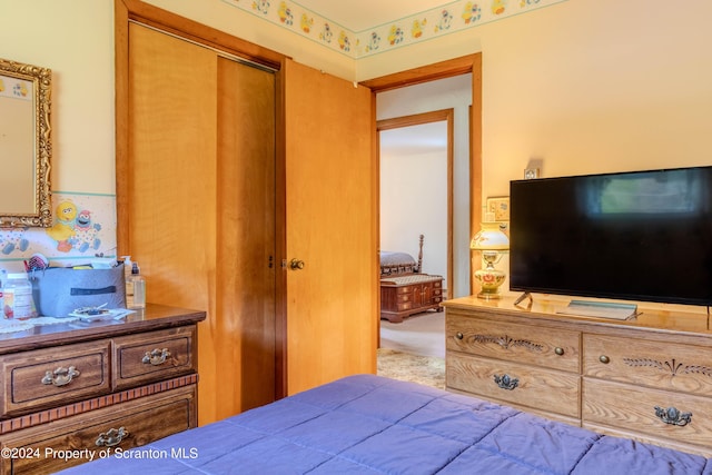 bedroom featuring carpet and a closet