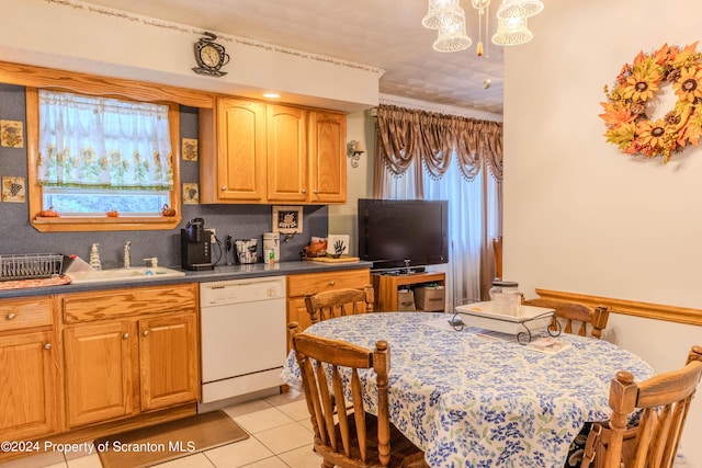 kitchen with pendant lighting, dishwasher, light tile patterned flooring, and sink