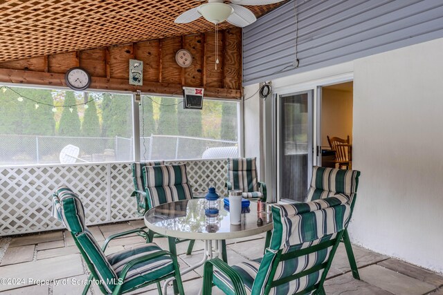 sunroom / solarium with ceiling fan and lofted ceiling