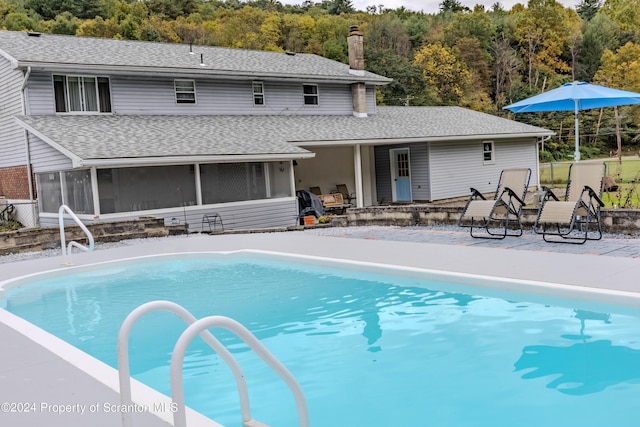 view of pool with a sunroom