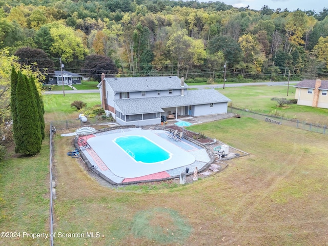 view of pool with a lawn and a patio