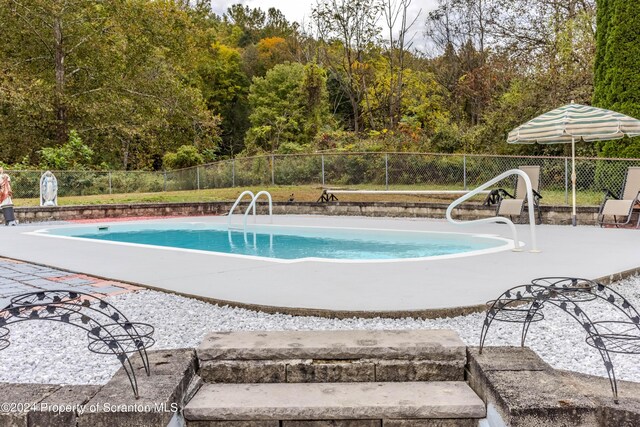 view of pool featuring a patio