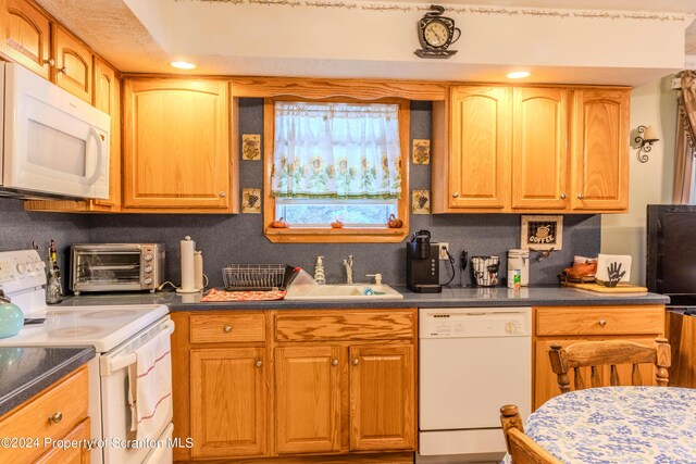 kitchen with white appliances and sink