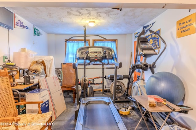 workout area featuring a textured ceiling