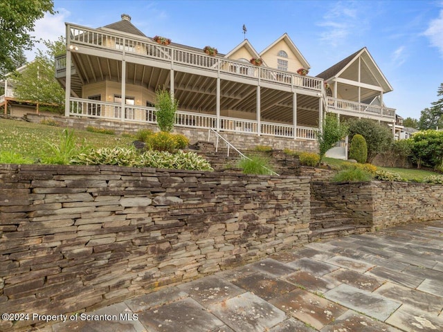 back of property with a balcony