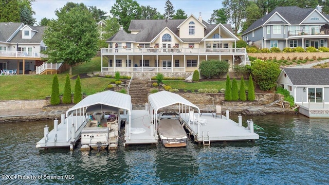 view of dock with a yard and a water view