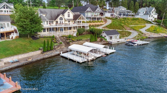 view of dock featuring a yard and a water view