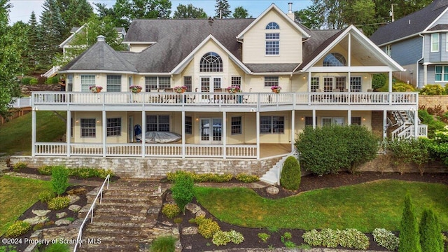 back of house featuring a yard and french doors