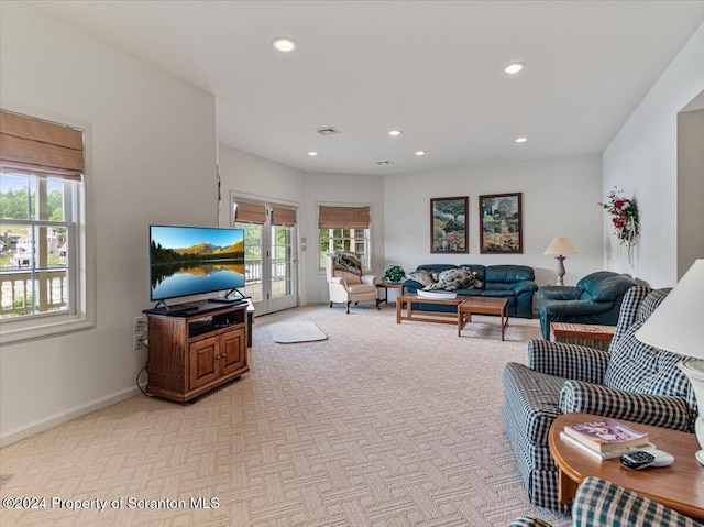 living room featuring light carpet and a wealth of natural light