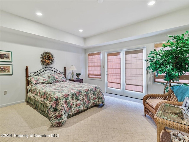 bedroom with access to exterior and light colored carpet