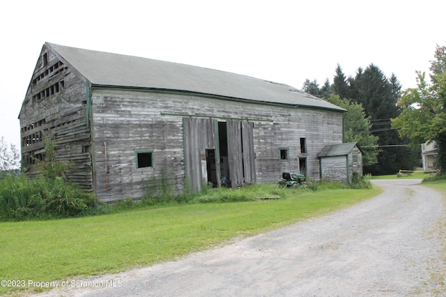 view of outbuilding with a lawn