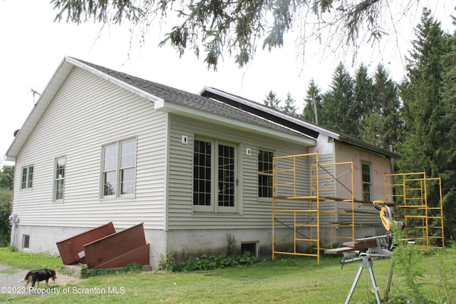 view of property exterior with a yard