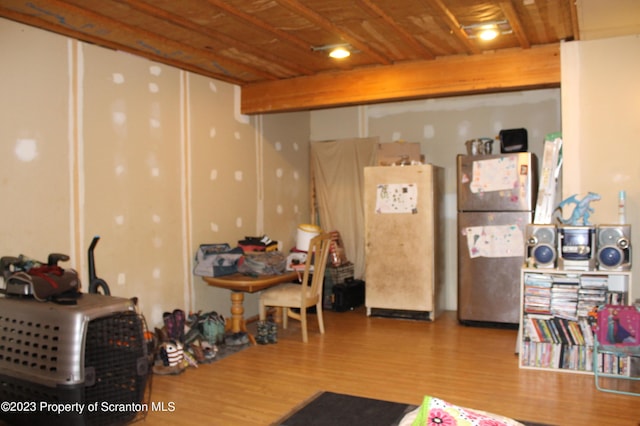 interior space featuring hardwood / wood-style flooring, white fridge, and stainless steel refrigerator