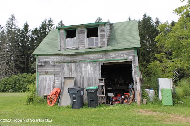 view of outbuilding featuring a lawn