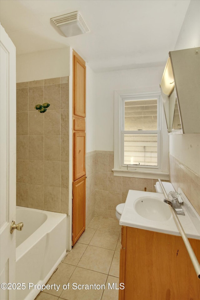 228 Pittston Ave, Scranton, PA 18505 - full bath with vanity, tile patterned flooring, tile walls, wainscoting, and toilet