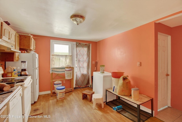 228 Pittston Ave, Scranton, PA 18505 - kitchen featuring under cabinet range hood, range, light wood-type flooring, and baseboards