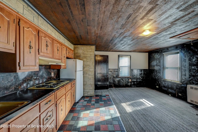 kitchen featuring dark countertops, electric cooktop, wood ceiling, under cabinet range hood, and wainscoting