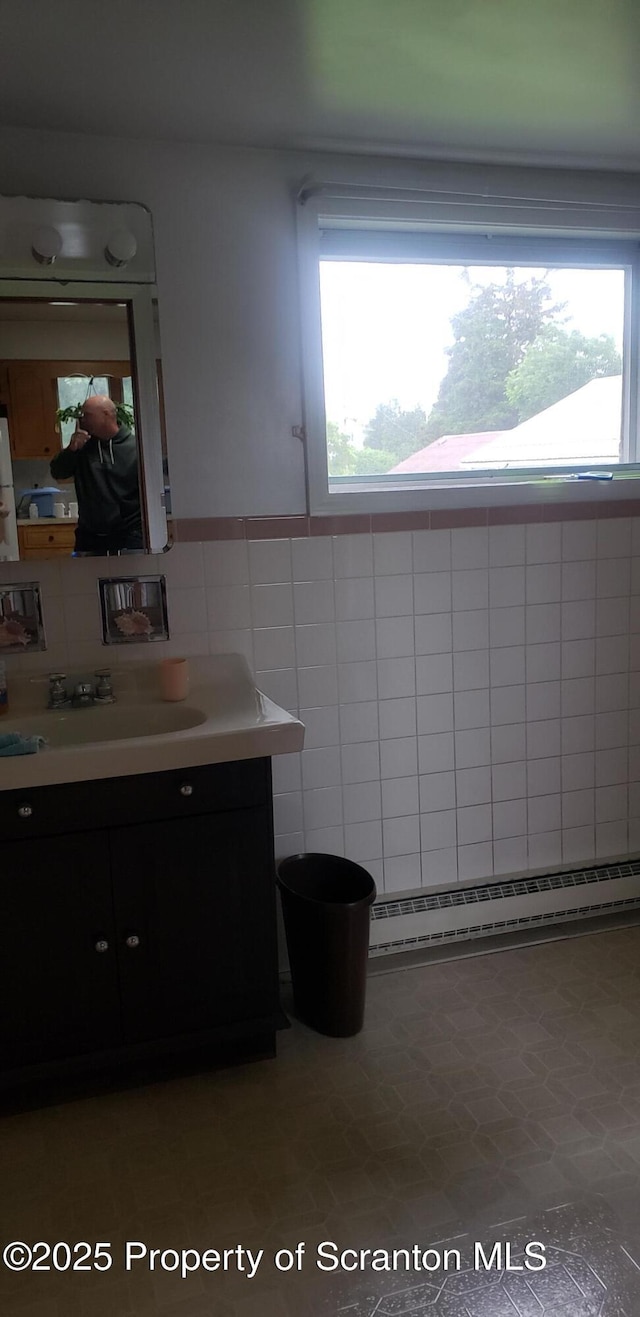 911 Prince St, Taylor, PA 18517 - bathroom featuring a baseboard radiator, vanity, and tile walls