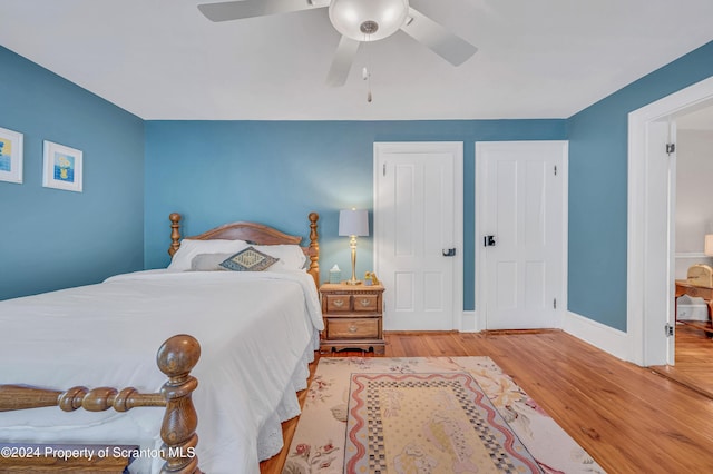 bedroom featuring light hardwood / wood-style flooring and ceiling fan