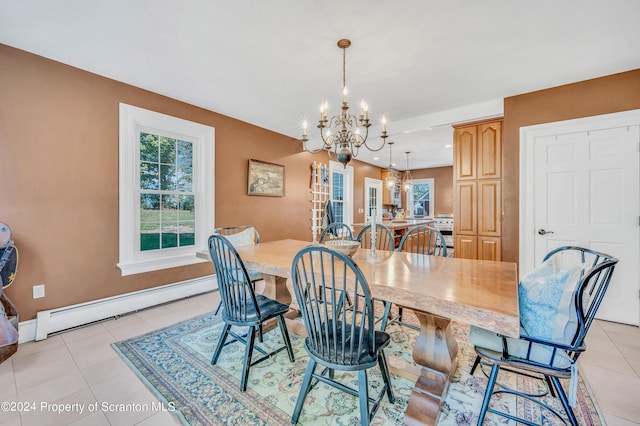 tiled dining area with a chandelier and a baseboard radiator