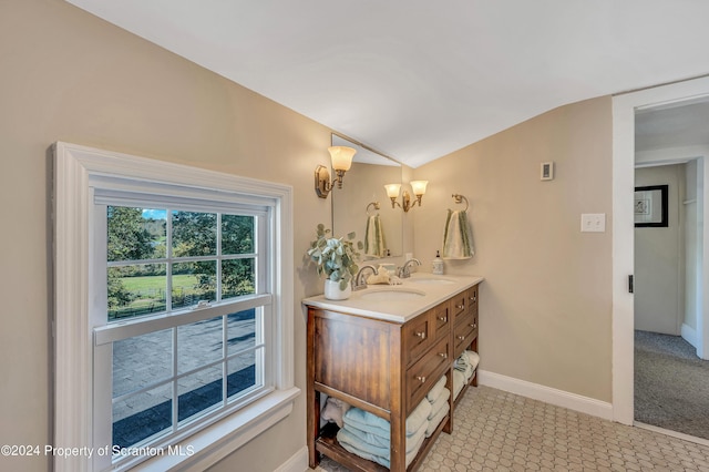 bathroom featuring vanity and vaulted ceiling