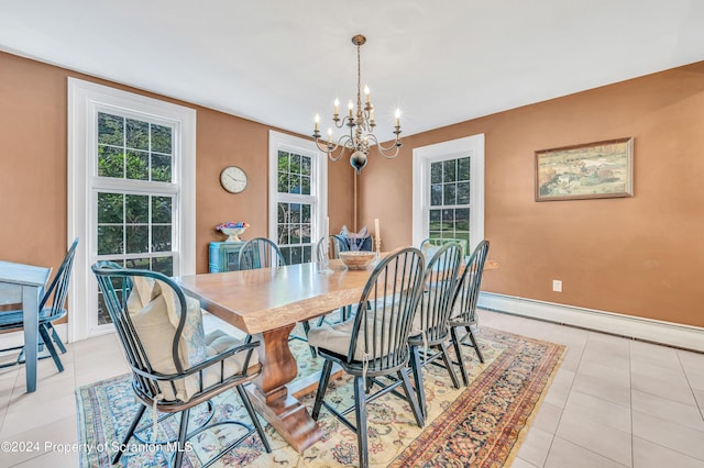 dining room with a notable chandelier, a baseboard heating unit, and light tile patterned flooring