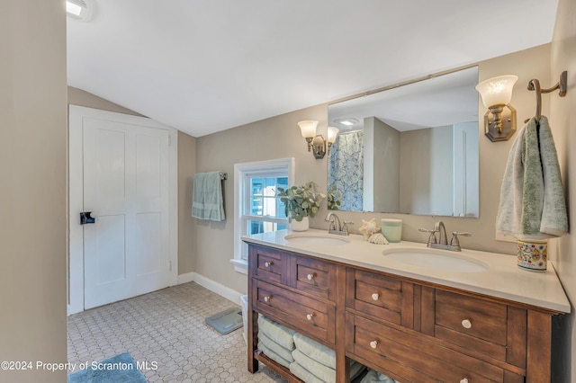 bathroom featuring tile patterned flooring, vanity, and vaulted ceiling