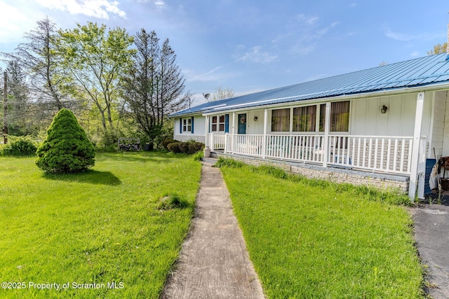 505 Yedinak Ln, Madison Twp, PA 18444 - view of front facade featuring covered porch, a front lawn, metal roof, and board and batten siding