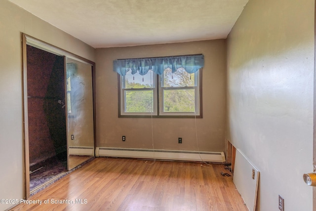 505 Yedinak Ln, Madison Twp, PA 18444 - unfurnished bedroom featuring a baseboard heating unit and light wood-type flooring