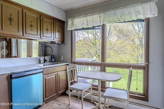 505 Yedinak Ln, Madison Twp, PA 18444 - kitchen with dishwasher, a sink, light wood-style floors, a baseboard heating unit, and brown cabinetry