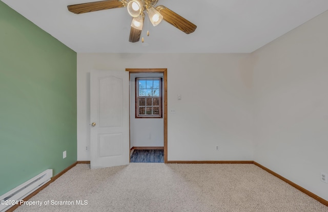 spare room featuring carpet floors, a baseboard radiator, and ceiling fan