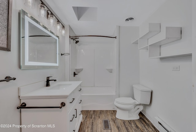 full bathroom with a baseboard radiator, washtub / shower combination, wood-type flooring, toilet, and vanity