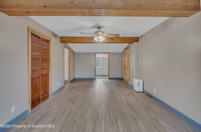 spare room featuring ceiling fan, light hardwood / wood-style flooring, and lofted ceiling with beams