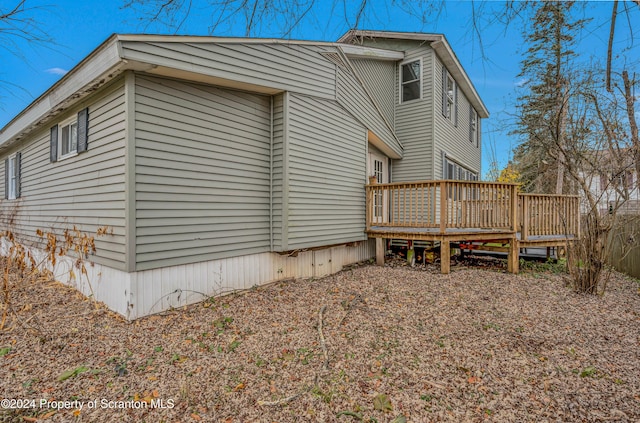 view of side of home with a deck