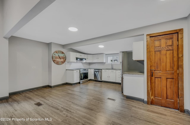 kitchen featuring backsplash, stainless steel appliances, sink, light hardwood / wood-style flooring, and white cabinetry