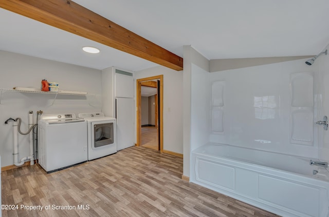 laundry room featuring washer and dryer and light hardwood / wood-style flooring