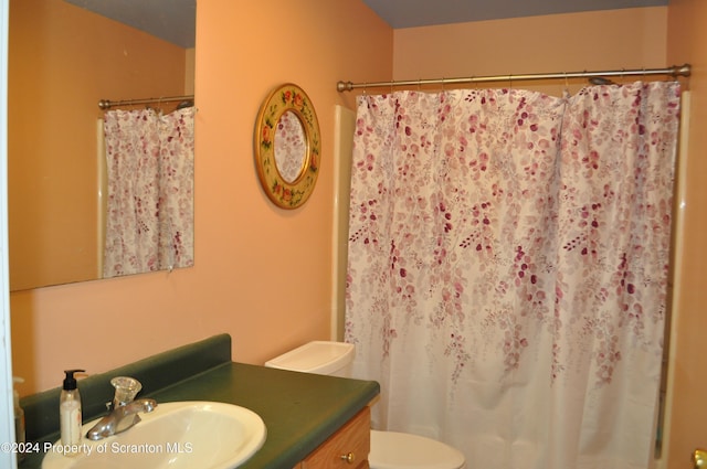 bathroom featuring vanity and toilet