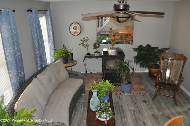 living room featuring hardwood / wood-style floors and ceiling fan