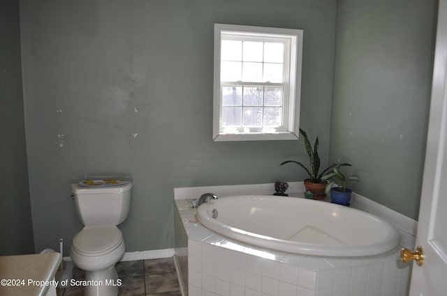 bathroom with tiled bath, tile patterned flooring, and toilet