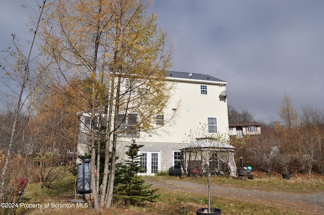 rear view of property with a gazebo and french doors