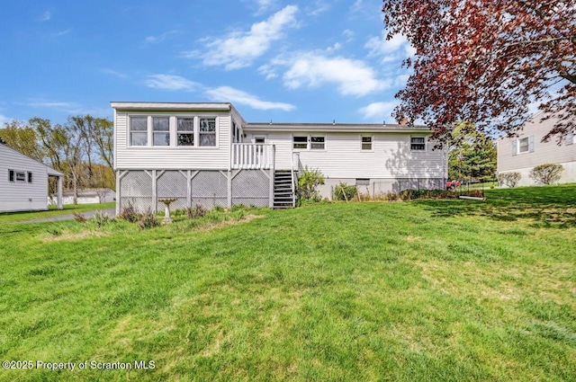 back of house with stairway, a lawn, and a wooden deck