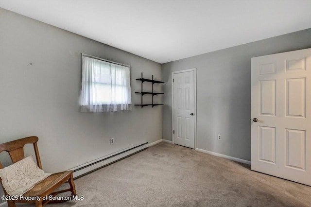 unfurnished bedroom featuring baseboards, carpet, and baseboard heating
