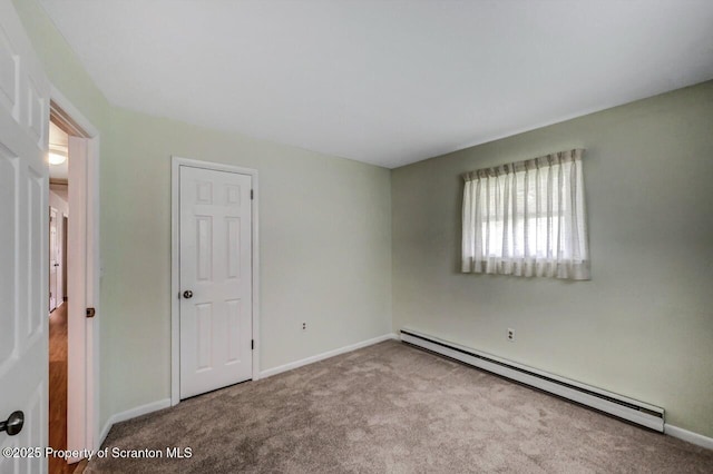 unfurnished bedroom featuring carpet floors, baseboards, and baseboard heating