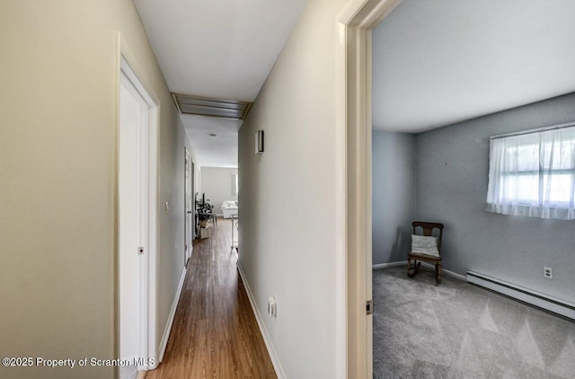 hallway with baseboards and a baseboard heating unit