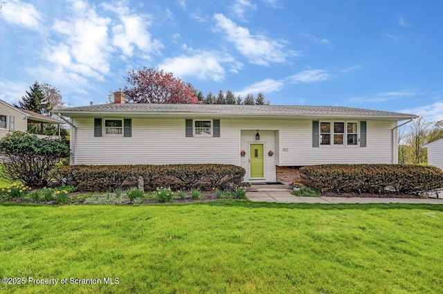 bi-level home with a chimney and a front yard