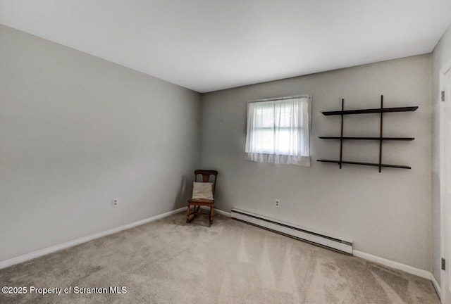 carpeted spare room with baseboards and a baseboard heating unit